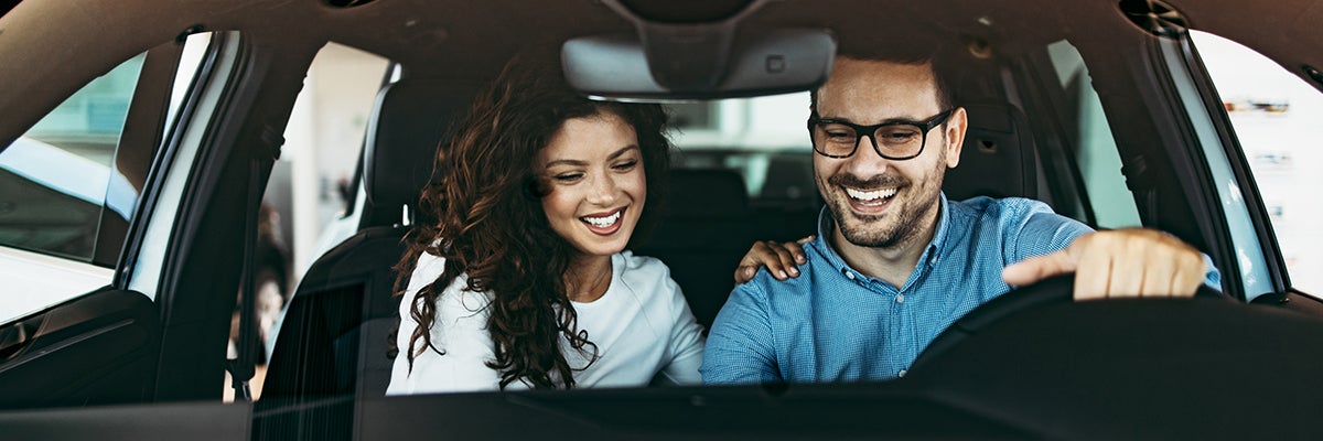 image of a man and woman in a car smiling
